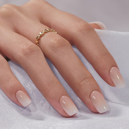Hand with pink gradient nails on a white background