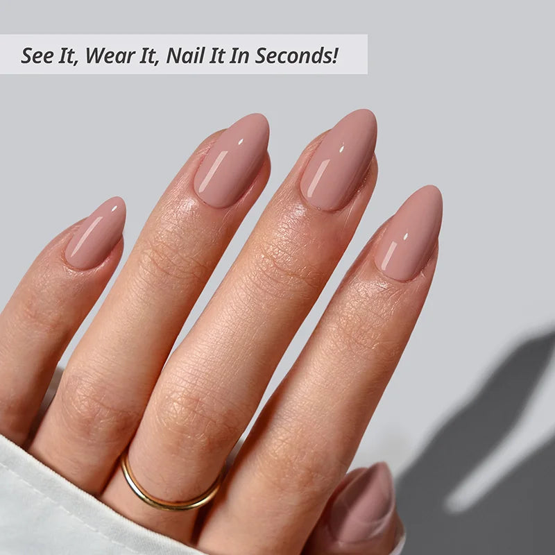 Hand with pink nail polish on a light gray background
