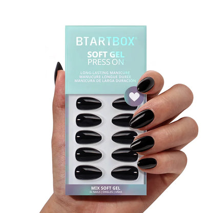 Hand holding a package of BTARTBOX soft gel press-on nails with black nails.
